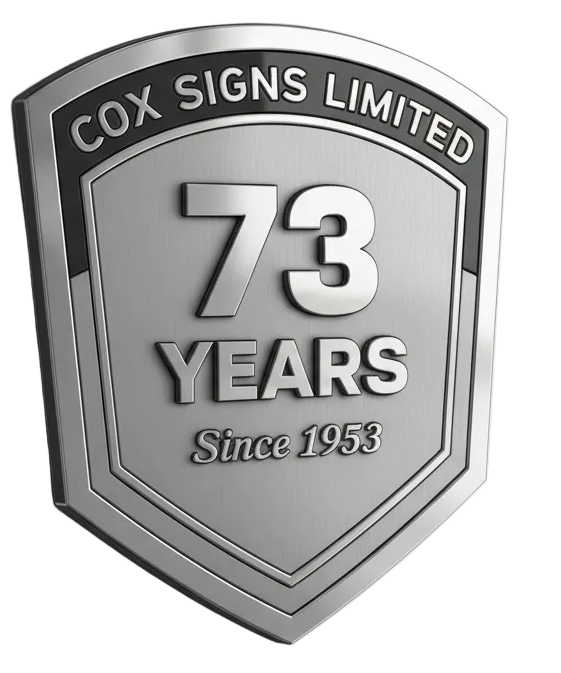 Silver emblem celebrating 73 years of Cox Signs Limited, with '73 Years Since 1953' text.